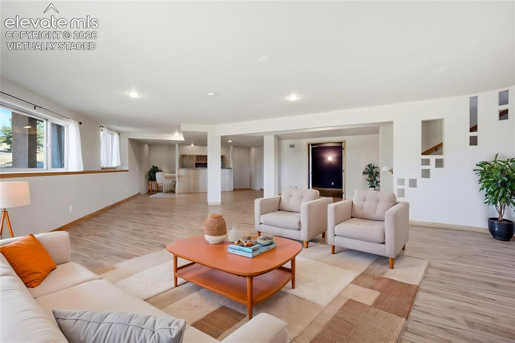 Image 5 of 39: Family Room with theater room adjacent and walkout to patio (virtually stag