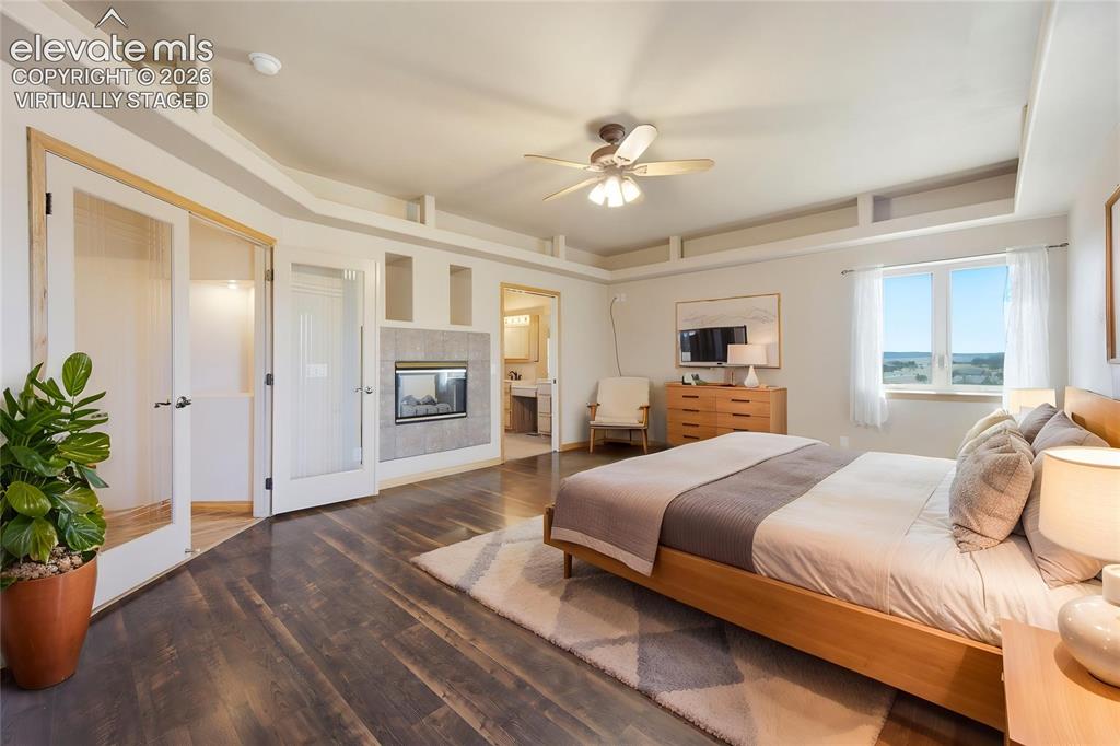 Image 7 of 48: Primary Bedroom with walkout to deck (virtually staged)