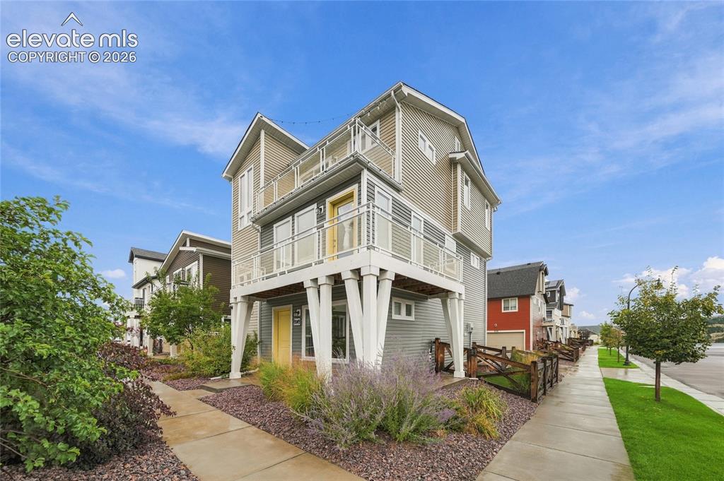 Caption: Multi-story exterior with horizontal siding and multiple balconies