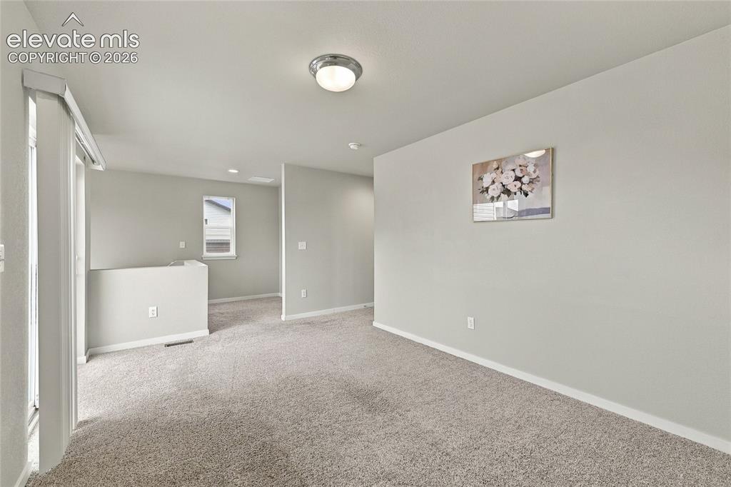 Image 19 of 30: Light gray painted walls with recessed lighting