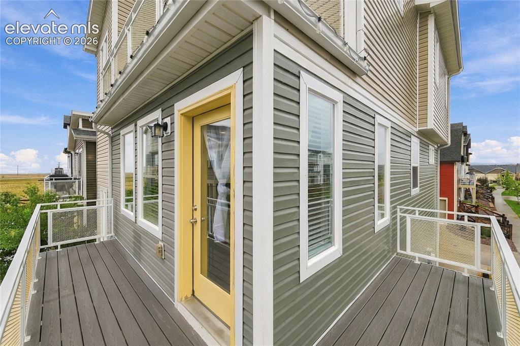 Image 24 of 30: Outdoor balcony with composite decking, white aluminum railings, and clear
