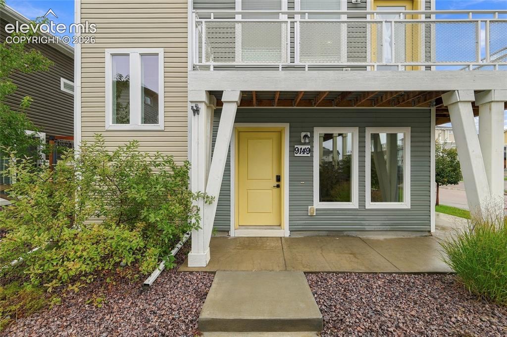 Image 5 of 30: Exterior featuring multi-tone siding, a yellow entry door, a concrete walkw