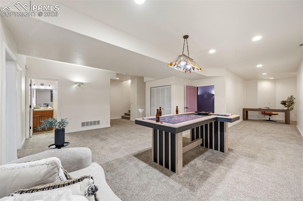 Image 25 of 50: Large recreation room with corner area currently set aside as office area