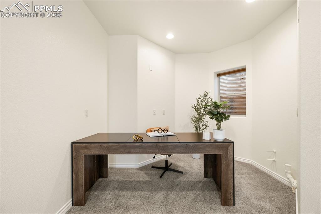 Image 26 of 50: Corner area uniquely set aside for an office, craft area or space for exerc