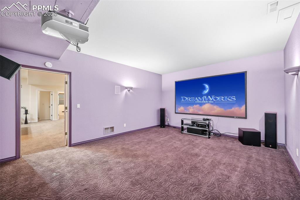 Image 27 of 50: Projector and surround sound speakers produce theater like quality for your