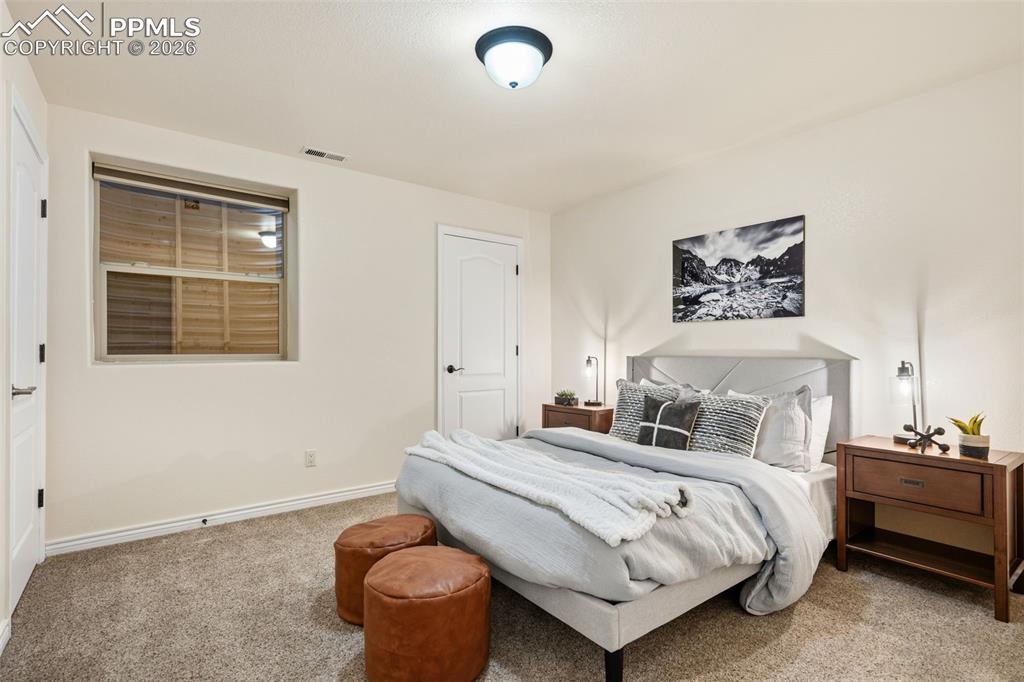 Image 29 of 50: Bedroom 4 downstairs also has a storage closet in addition to regular cloth