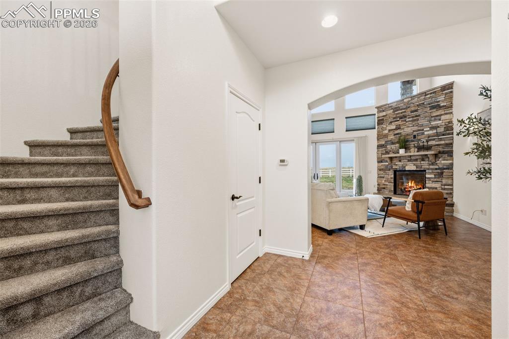Image 8 of 50: Curved staircase leads up to loft, bedroom, and full bath