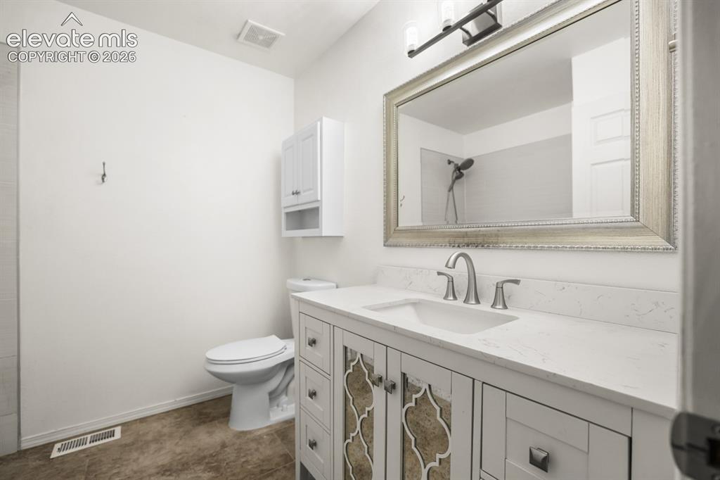 Image 28 of 49: Second bathroom conveniently located near kitchen and living on the second 