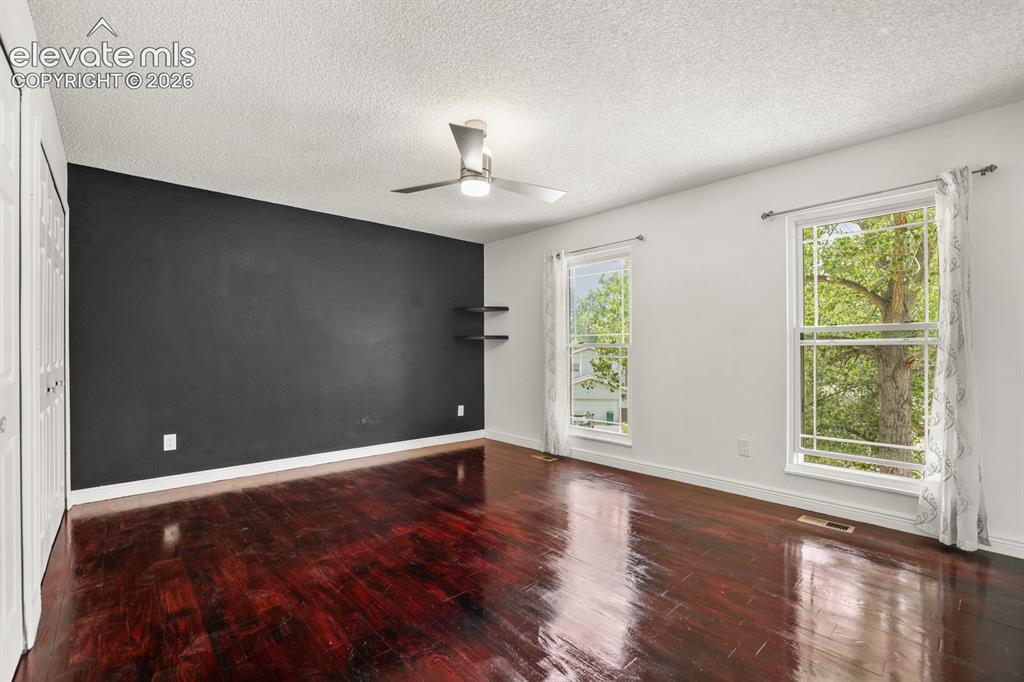 Image 30 of 49: Large Main bedroom with attached bath.