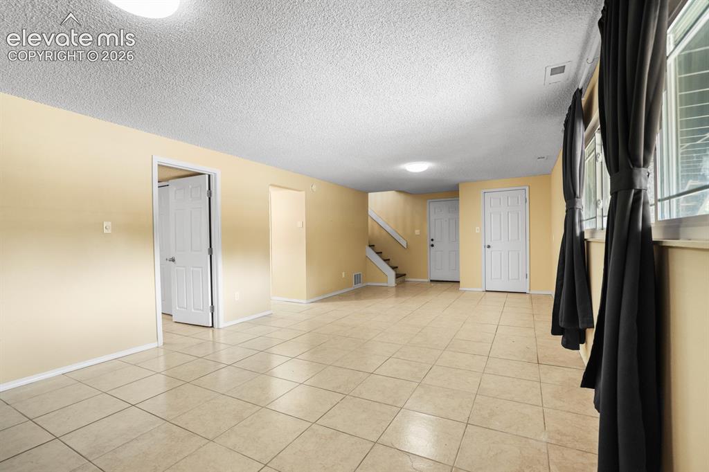 Image 39 of 49: Opposite view of the big bright family room on the lower level.  It is so b