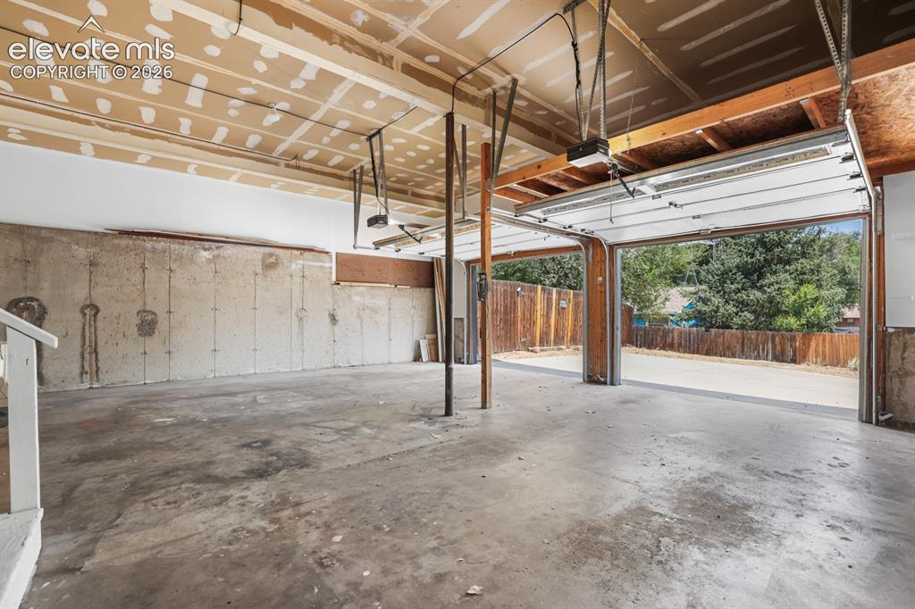 Image 44 of 49: oversized garage with plenty of room for storage, or workshop.  Comeswith  