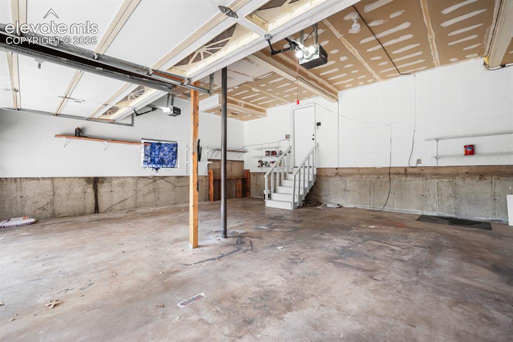 Image 45 of 49: view from the garage door entrance back to home entry into the gardern leve