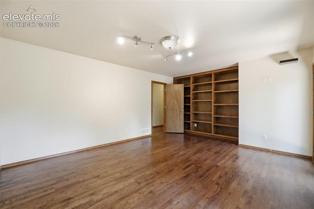 Image 31 of 50: w/ Built-in Shelving and Private Juliet Balcony