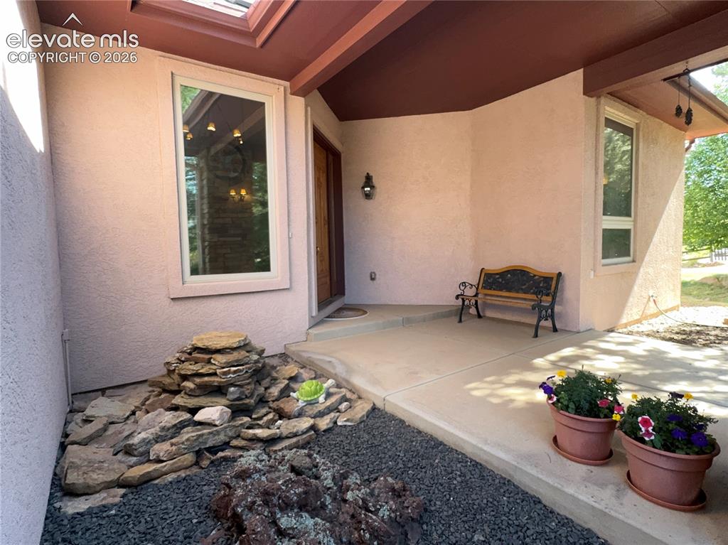 Image 39 of 48: Front Porch with water fountain