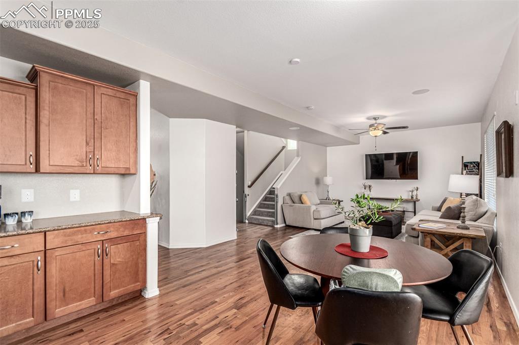 Image 10 of 41: Dining space with stairway, light wood-style flooring, and ceiling fan