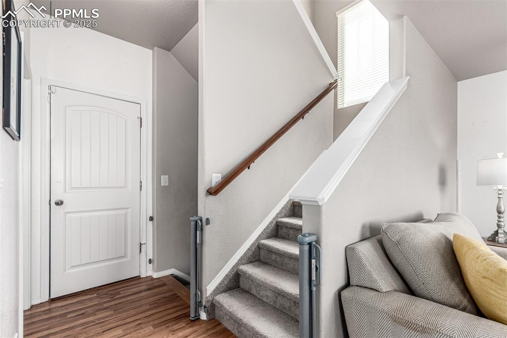 Image 15 of 41: Staircase featuring wood finished floors and baseboards