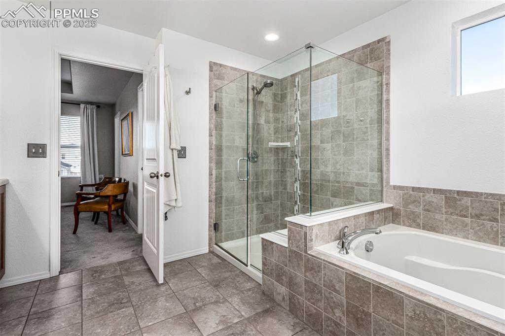 Image 19 of 41: Bathroom with a garden tub, a shower stall, and vanity
