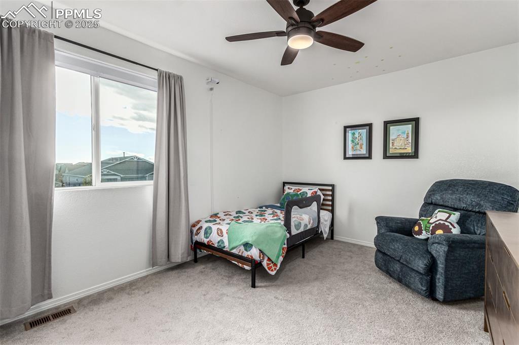 Image 23 of 41: Bedroom featuring light colored carpet and ceiling fan