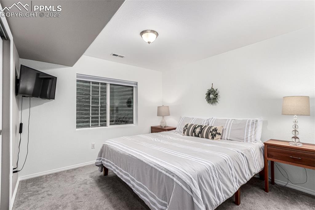 Image 29 of 41: Bedroom featuring light carpet and baseboards
