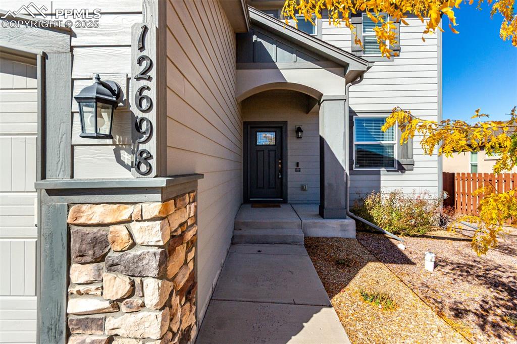 Image 3 of 41: Entrance to property with stone siding
