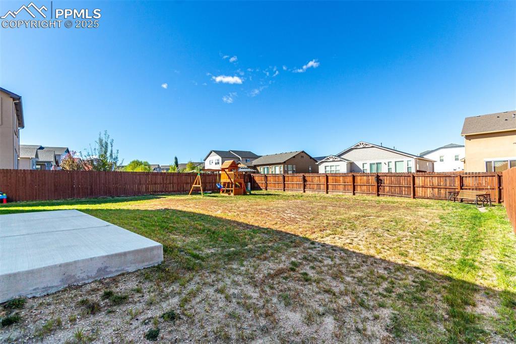 Image 37 of 41: Fenced backyard featuring a residential view and a playground
