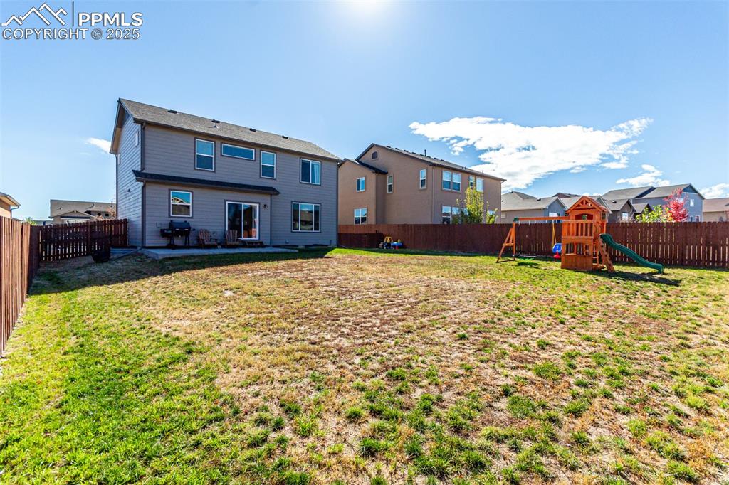 Image 38 of 41: Rear view of house featuring a fenced backyard, a patio, a residential view