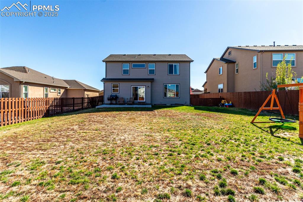 Image 39 of 41: Back of house with a patio and a fenced backyard