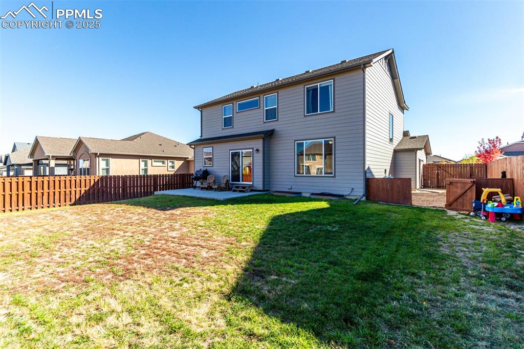 Image 40 of 41: Rear view of house with a patio and a fenced backyard