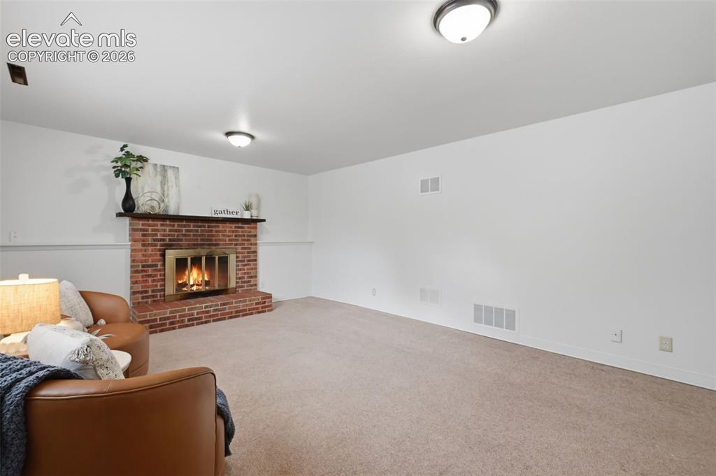 Image 18 of 35: Downstairs living room with real wood fireplace!