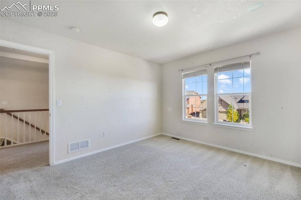 Image 29 of 50: Carpeted spare room with baseboards