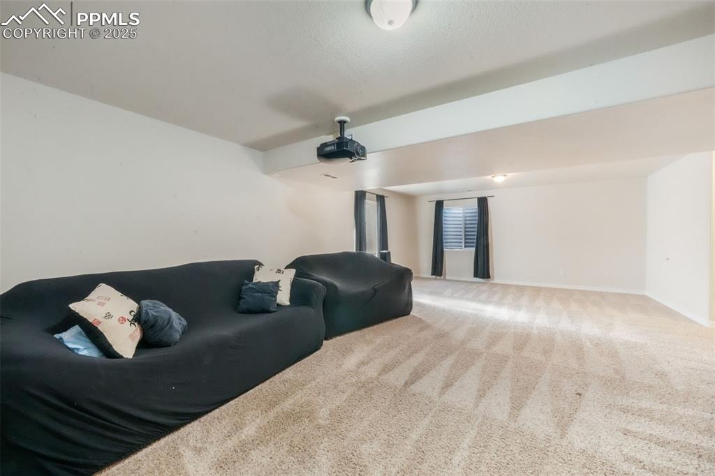 Image 36 of 50: Cinema room with carpet and baseboards