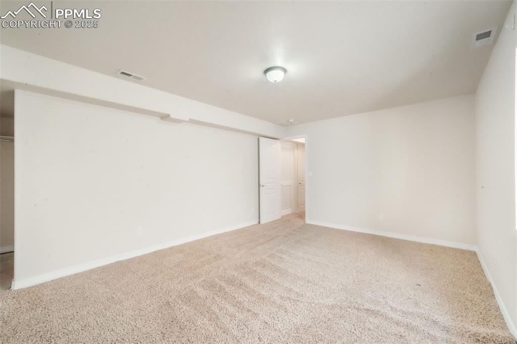 Image 41 of 50: Unfurnished bedroom featuring carpet floors and baseboards