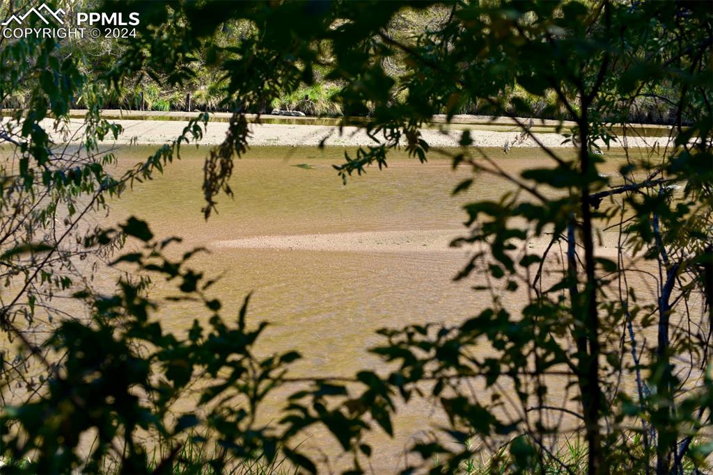 Image 7 of 20: Surrounding community with a water view