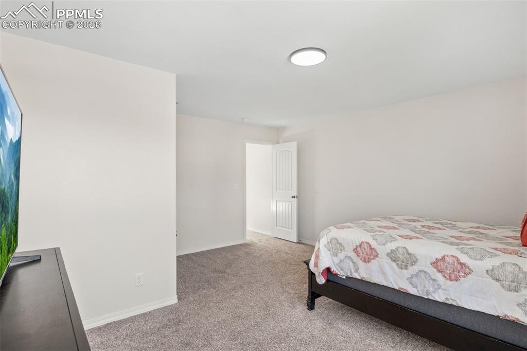 Image 15 of 25: Carpeted interior space featuring white walls and a white paneled door