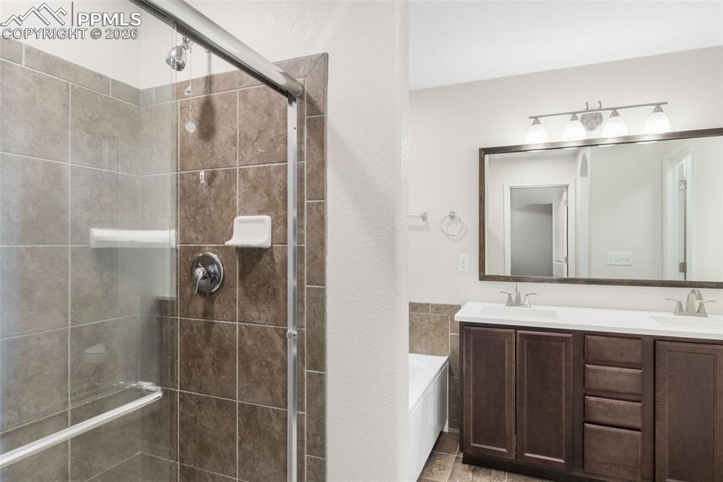 Image 16 of 25: Contemporary bathroom featuring a glass-enclosed shower with tiled walls, a