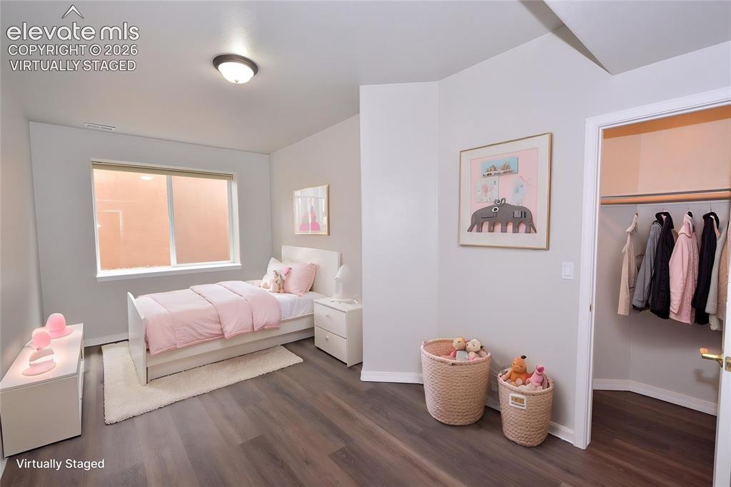 Image 24 of 33: virtually staged basement bedroom