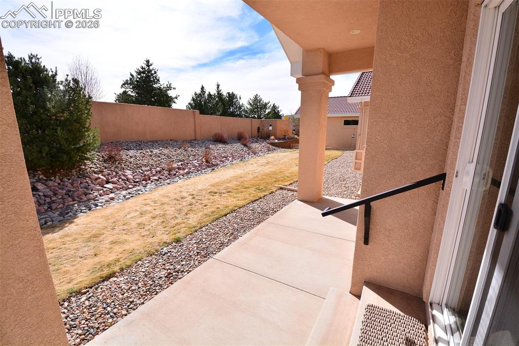 Image 34 of 50: Covered patio in back of home
