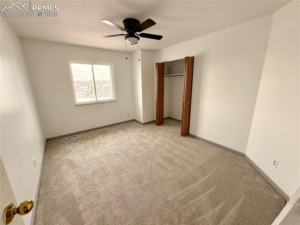 Image 13 of 42: Unfurnished bedroom featuring carpet floors, ceiling fan, and a closet