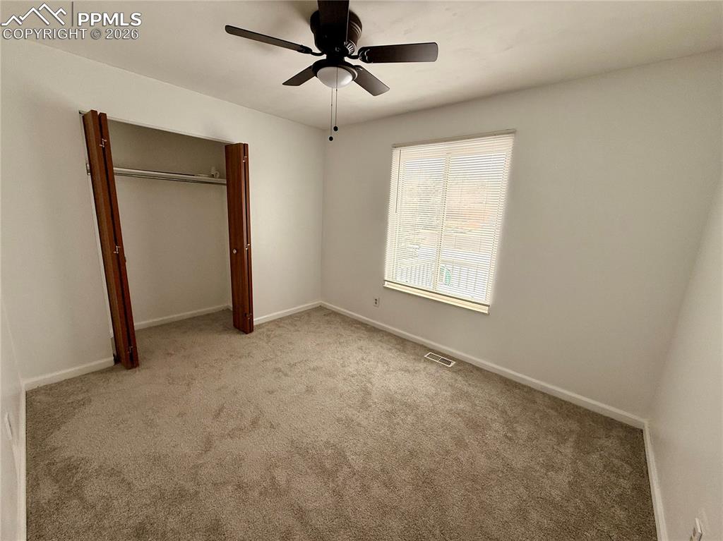 Image 19 of 42: Unfurnished bedroom featuring carpet, ceiling fan, and a closet