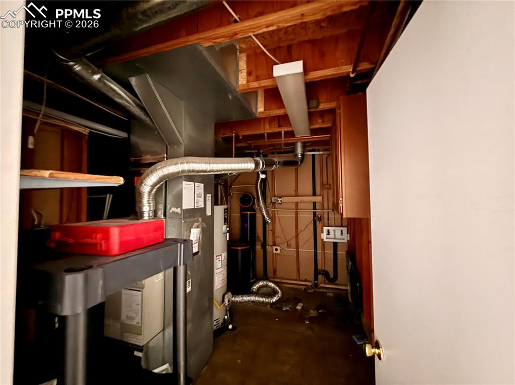 Image 26 of 42: Utility room with gas water heater
