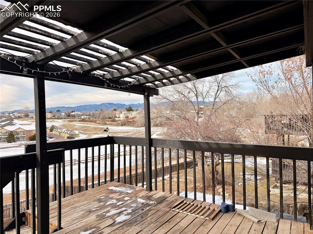 Image 35 of 42: Wooden deck featuring a mountain view and a pergola