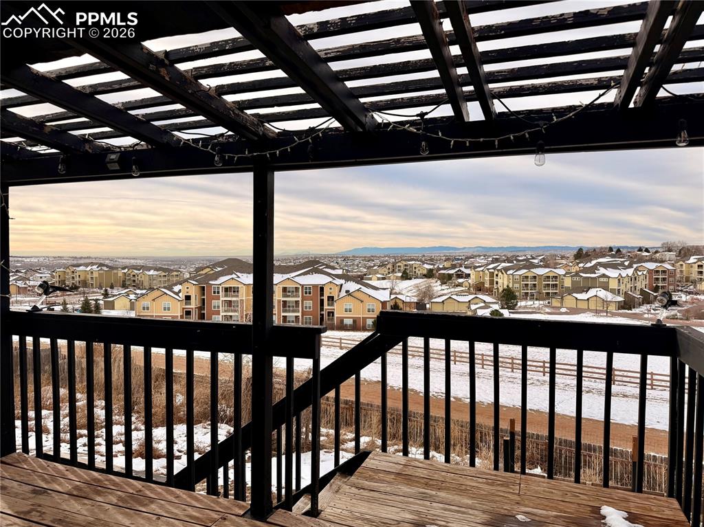 Image 36 of 42: Wooden terrace with a residential view