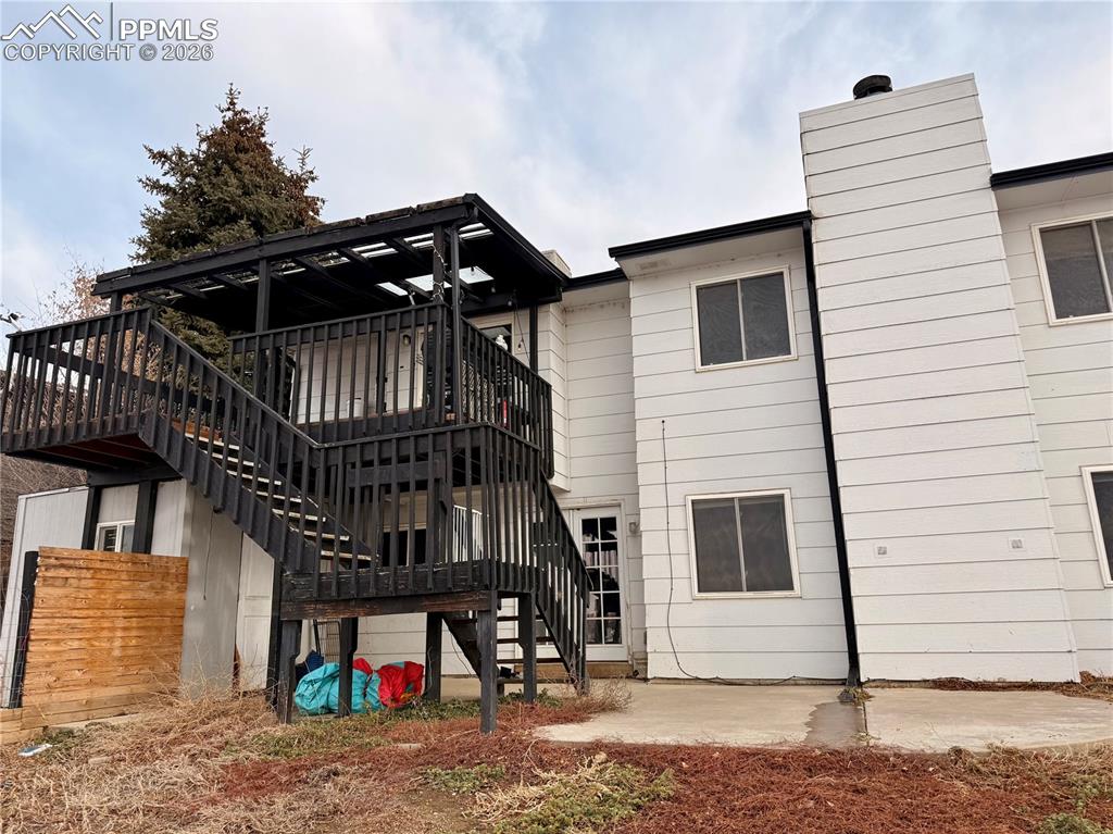 Image 38 of 42: Back of house featuring stairs, a patio, and a wooden deck