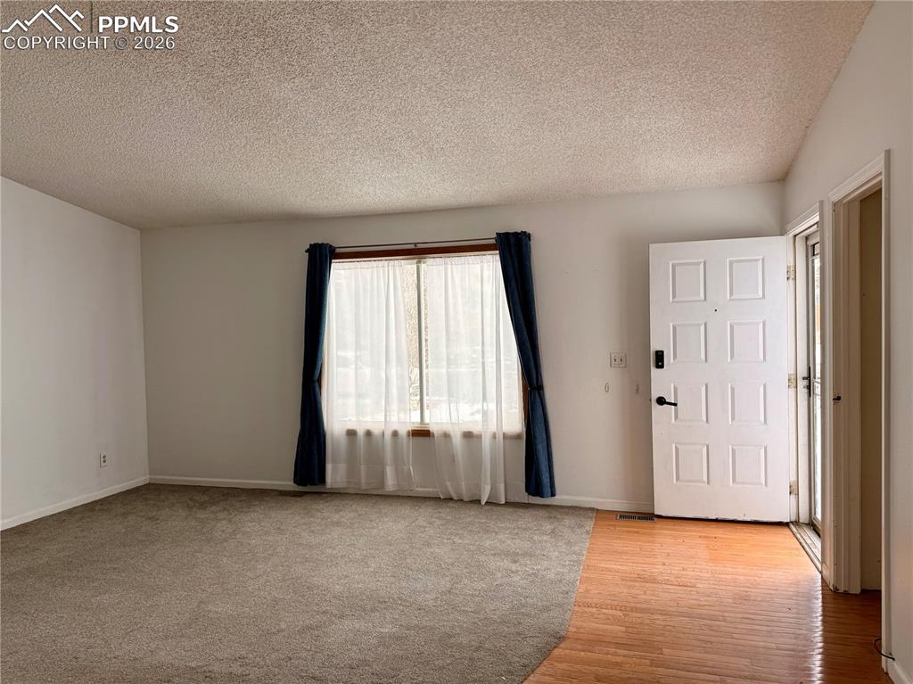 Image 4 of 42: Foyer featuring a textured ceiling and light wood finished floors