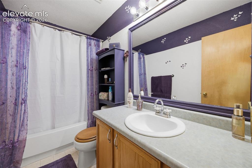 Image 11 of 27: Bathroom vanity featuring a white countertop with integrated sink, chrome f