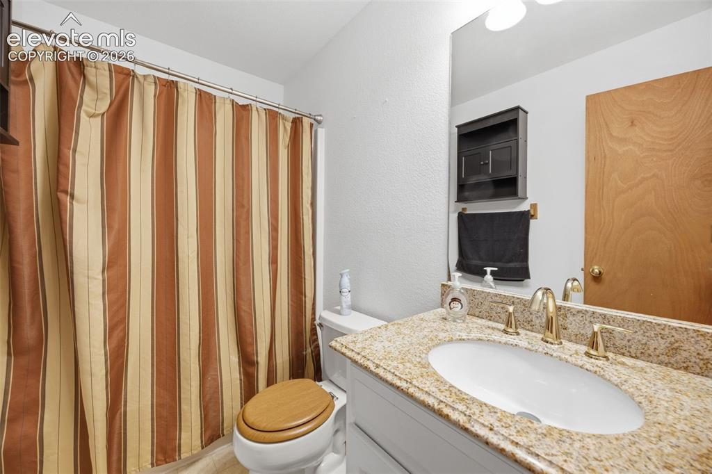 Image 14 of 27: PrimaryBathroom featuring a single vanity with a laminate countertop, under