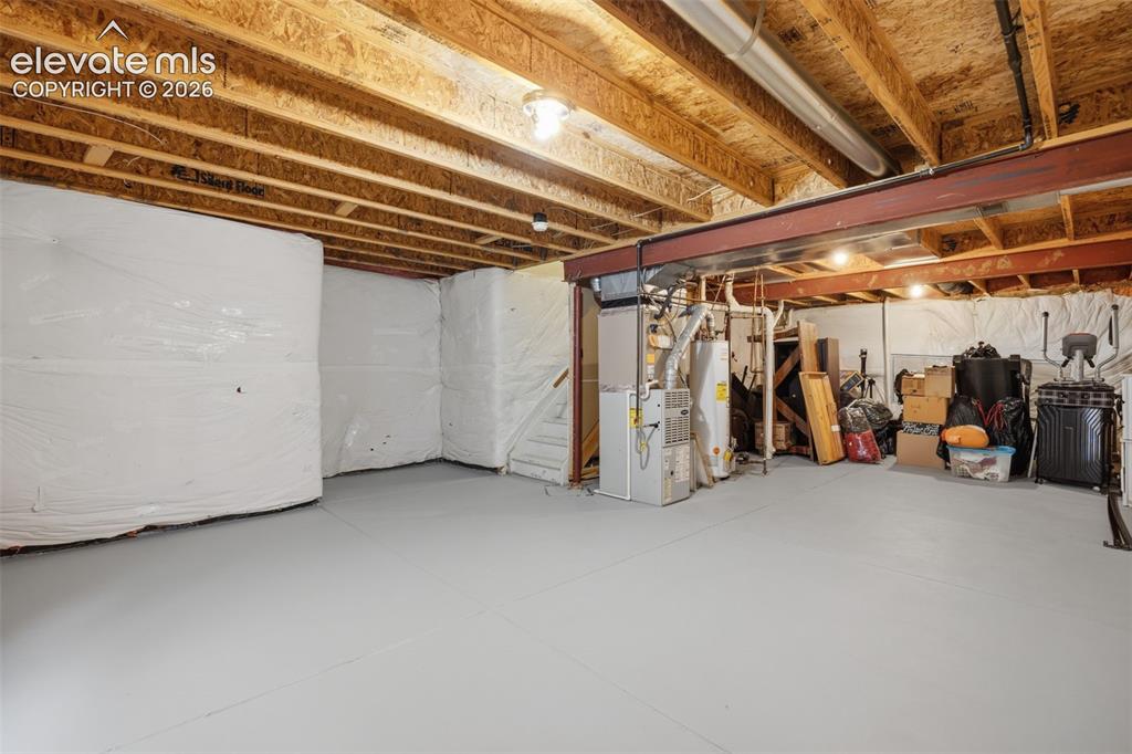 Image 19 of 27: Carpeted room with a ceiling fan, a window, and a blue accent wall