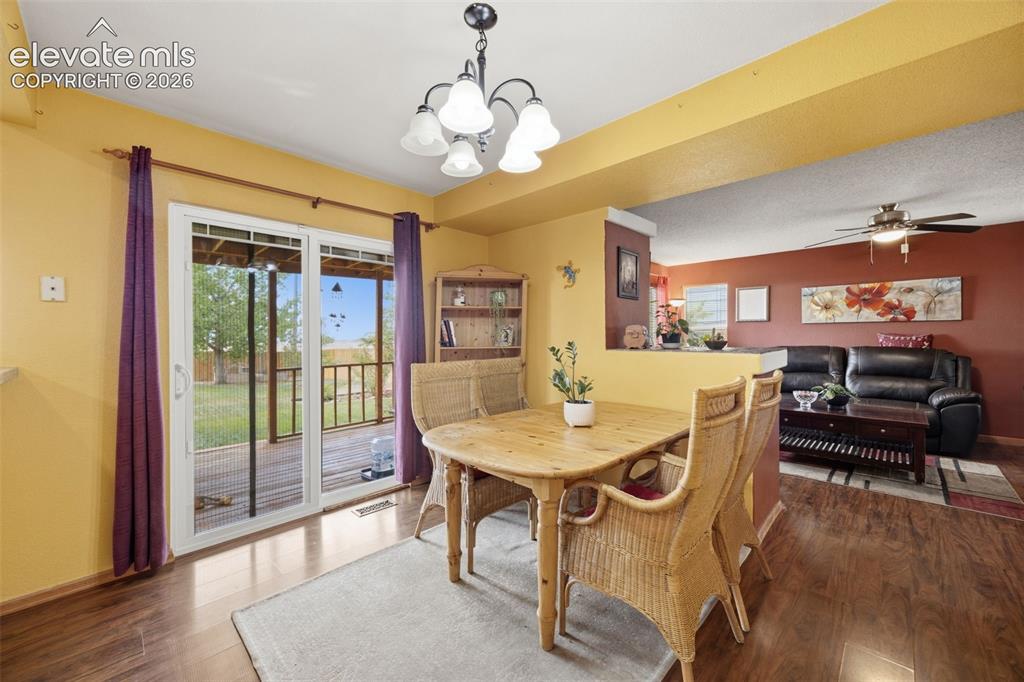 Image 5 of 27: Covered concrete front porch featuring a screen door, two-tone siding, and 