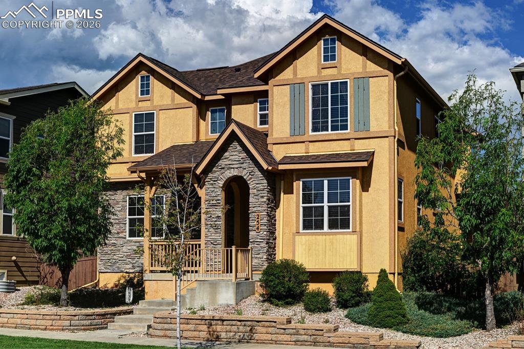 Image 1 of 33: Classic modern Tudor design with inviting front porch and mountain views, c