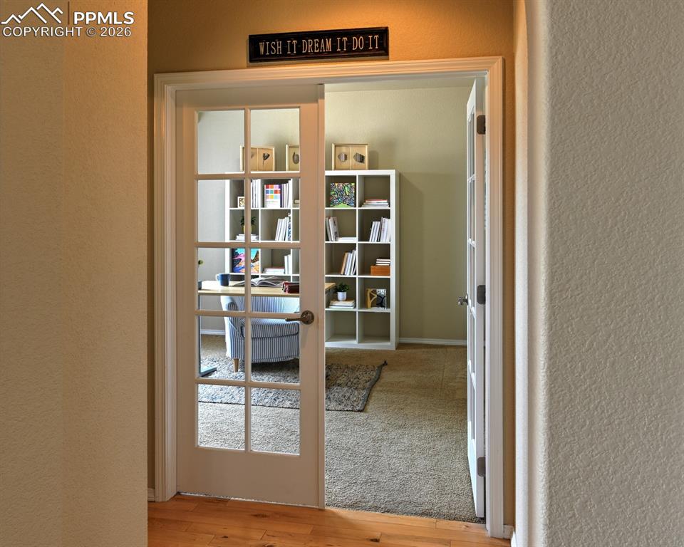 Image 11 of 33: French doors open to a private office, offering a quiet space for work or s